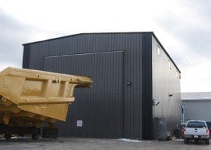 image of industrial equipment storage steel building with bi-fold door