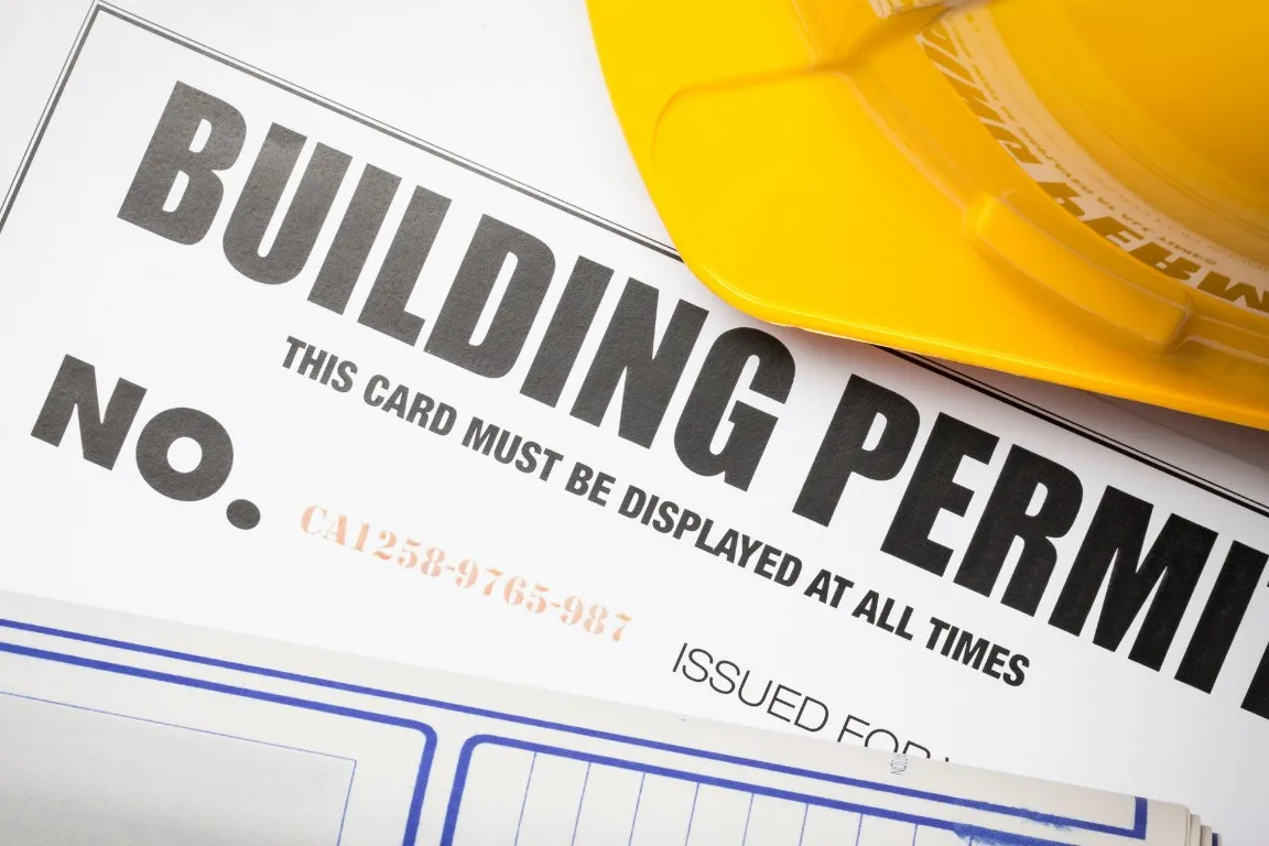 Building permit card with engineered drawings and a hard hat
