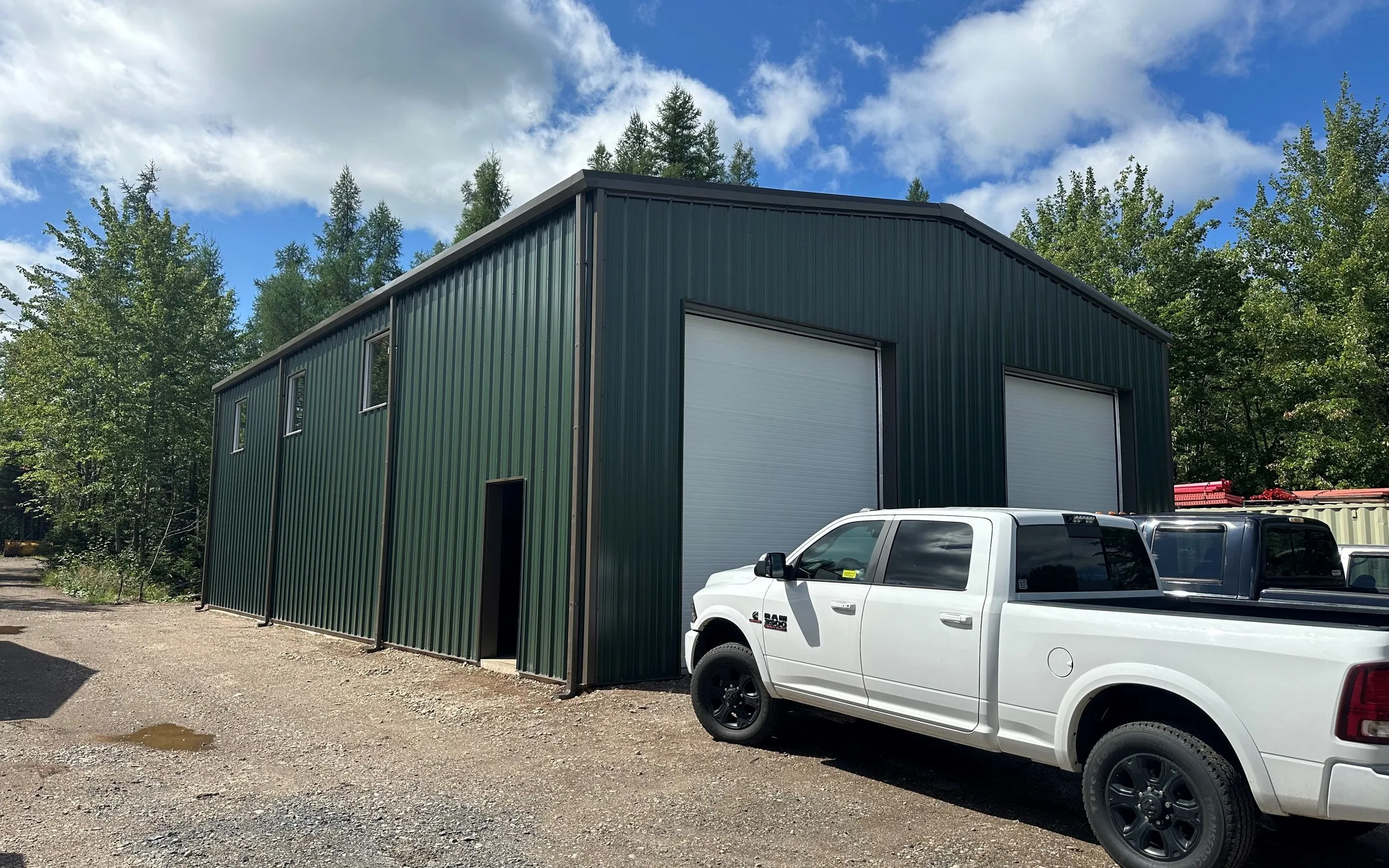 Green 40 by 60 steel building with overhead doors