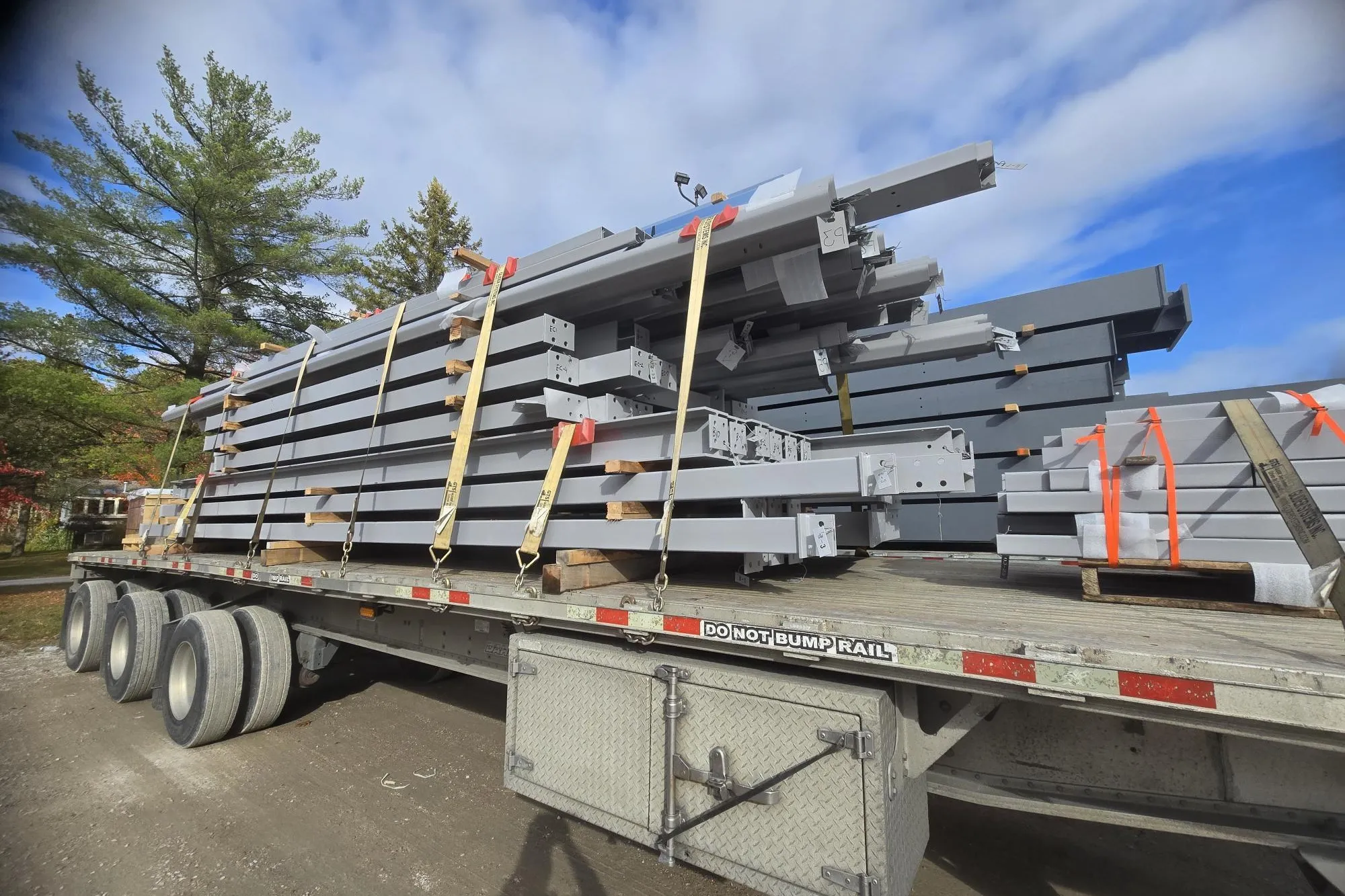 Steel building components loaded on a flatbed for delivery within Canada